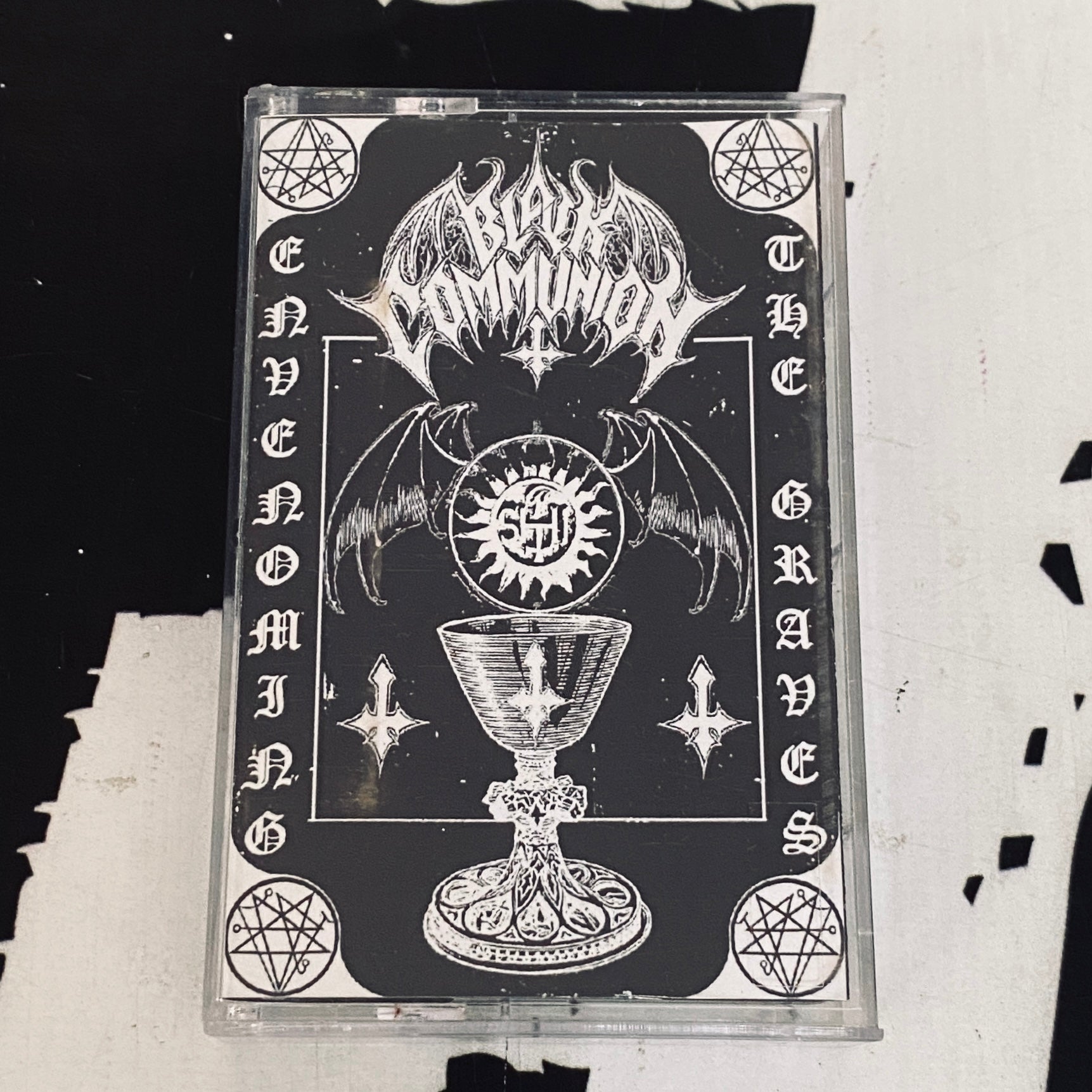 BLACK COMMUNION: Envenoming the Grave (Tape)